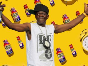 a yellow background with bottles of 1-hour energy and clocks, with an image of Flavor Flav overlaid