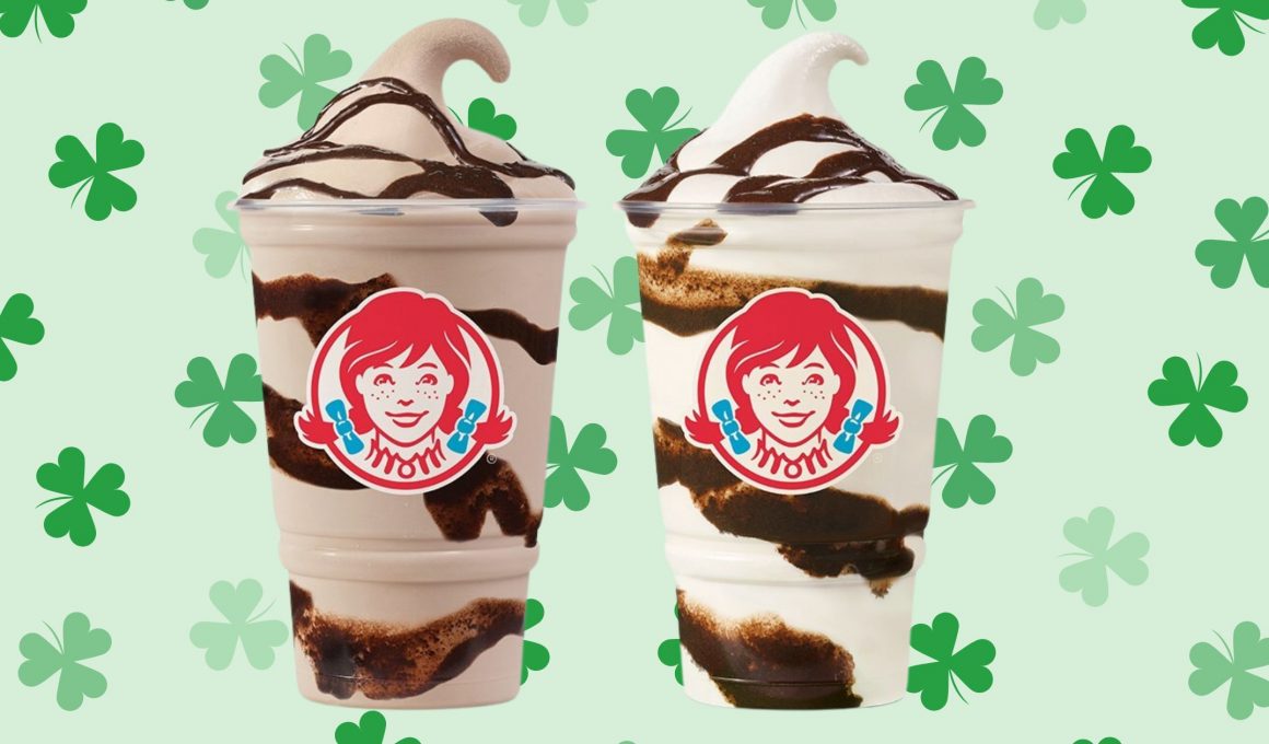 two wendy's frosty cups on a green shamrock background
