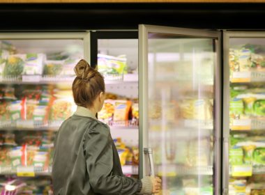 woman looking in a grocery freezer