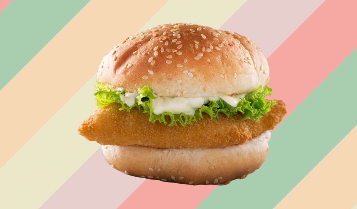 a fish sandwich on a colorful striped background