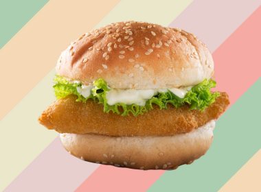 a fish sandwich on a colorful striped background