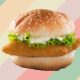 a fish sandwich on a colorful striped background