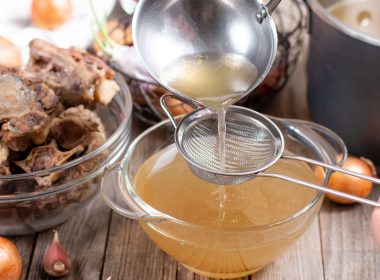 bone broth being poured into a cup