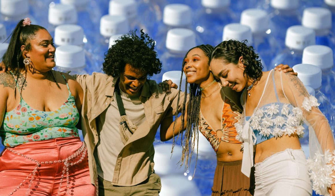 group of friends at a concert overlayed on a photo of water bottles