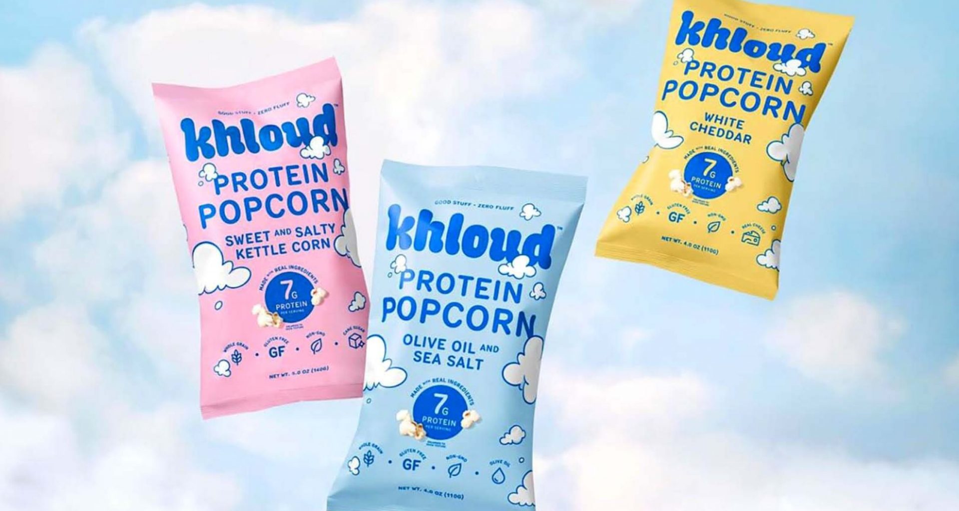 bags of khloud protein popcorn on a blue background with white clouds