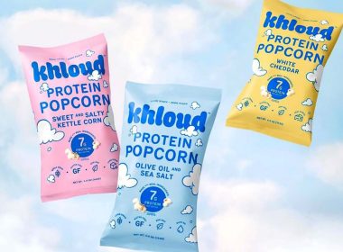 bags of khloud protein popcorn on a blue background with white clouds